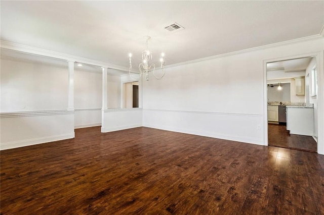 empty room with dark hardwood / wood-style flooring, crown molding, and a chandelier