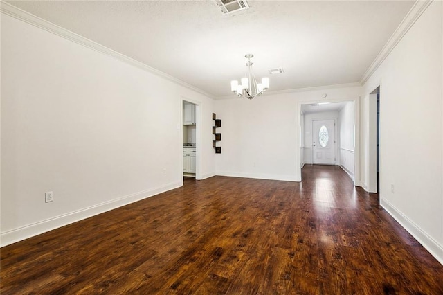 empty room with ornamental molding, dark wood-type flooring, and a chandelier