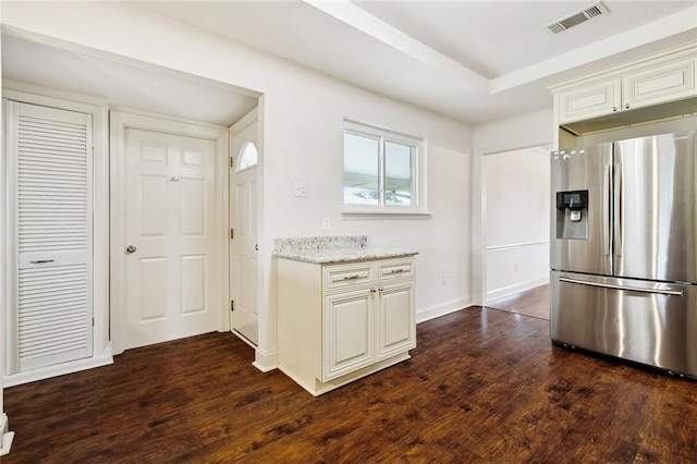 3512 James Dr, Metairie, LA 70003 - kitchen featuring visible vents, light stone countertops, baseboards, dark wood-style floors, and stainless steel fridge with ice dispenser