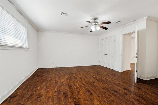 spare room with ceiling fan, ornamental molding, and dark hardwood / wood-style floors