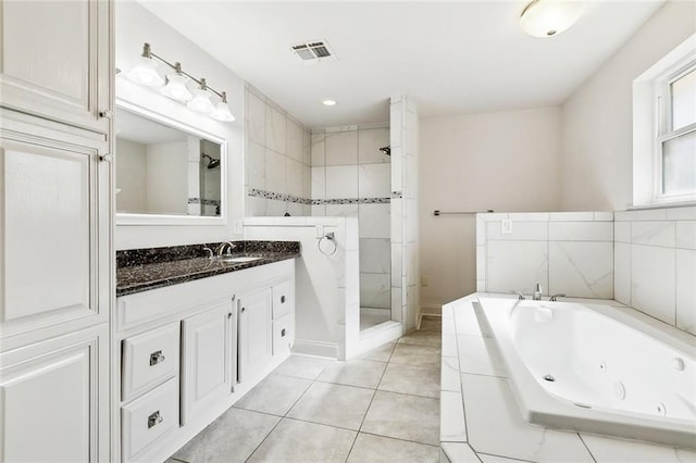 bathroom featuring tile patterned floors, plus walk in shower, and vanity