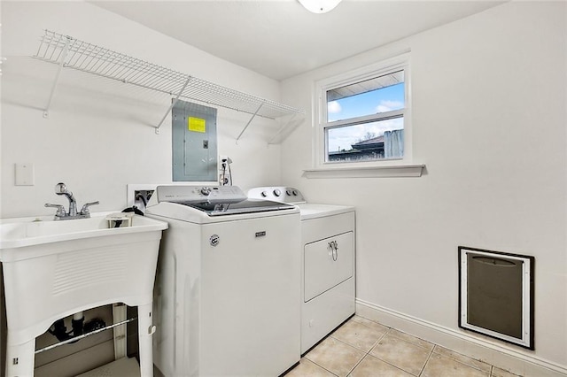 laundry room featuring light tile patterned flooring, washing machine and clothes dryer, electric panel, and sink