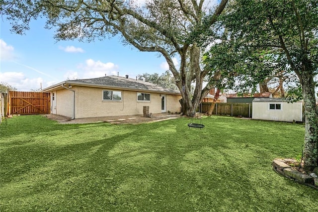 3512 James Dr, Metairie, LA 70003 - rear view of house with brick siding, a fenced backyard, a gate, an outbuilding, and a lawn
