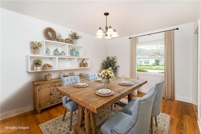 dining room with wood-type flooring and a chandelier