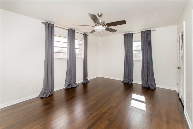 spare room featuring dark wood-type flooring and ceiling fan