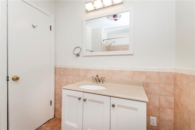 bathroom with vanity, tile patterned flooring, and tile walls