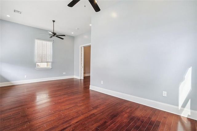 spare room with dark wood-type flooring and ceiling fan