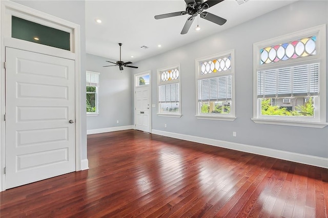 spare room featuring dark wood-type flooring and ceiling fan