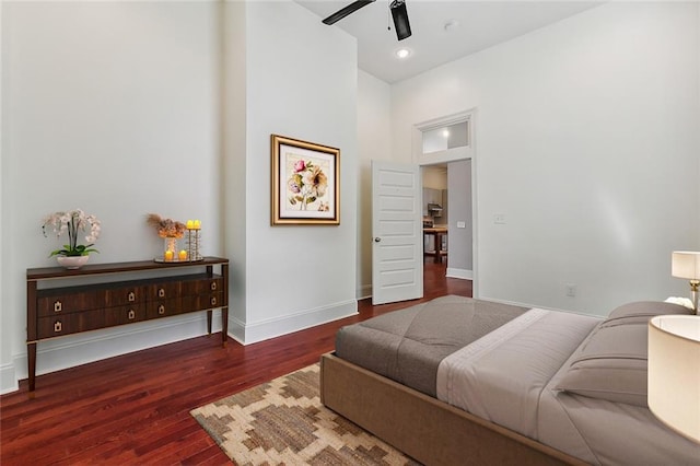 bedroom with ceiling fan and dark hardwood / wood-style floors