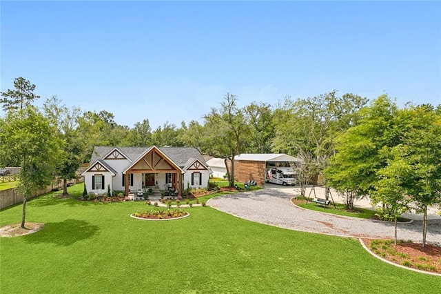 view of front of property with a carport, a porch, and a front yard