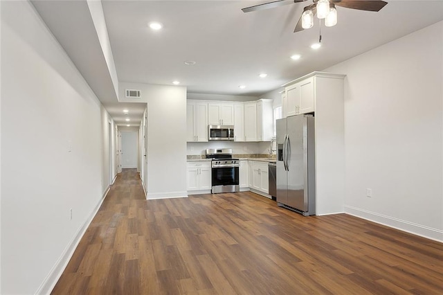 kitchen featuring dark wood-style floors, visible vents, light countertops, appliances with stainless steel finishes, and white cabinetry