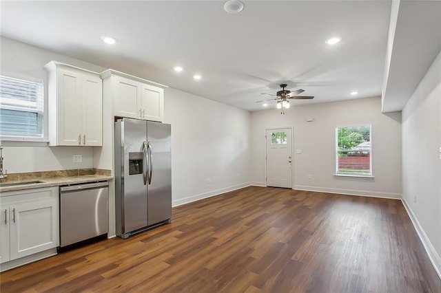 kitchen with baseboards, recessed lighting, stainless steel appliances, dark wood-style floors, and white cabinetry