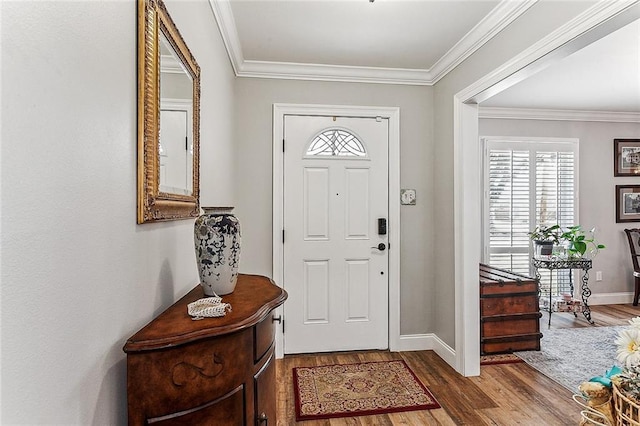 foyer entrance featuring ornamental molding and wood-type flooring