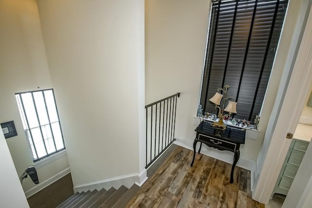 hallway with hardwood / wood-style floors