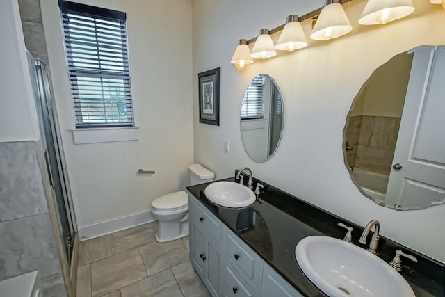 bathroom featuring vanity, toilet, and walk in shower