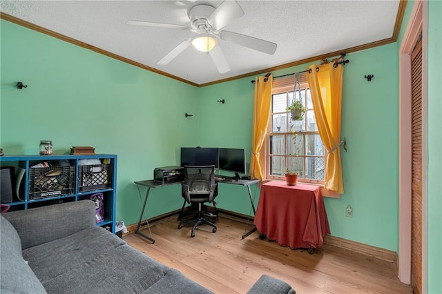 office space featuring ceiling fan, light hardwood / wood-style flooring, ornamental molding, and a textured ceiling