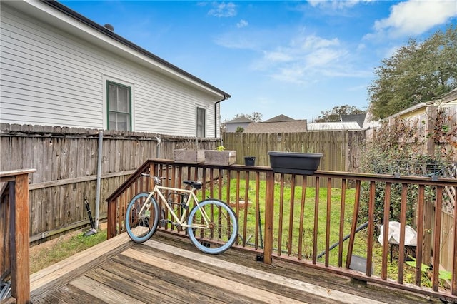 wooden deck featuring a lawn