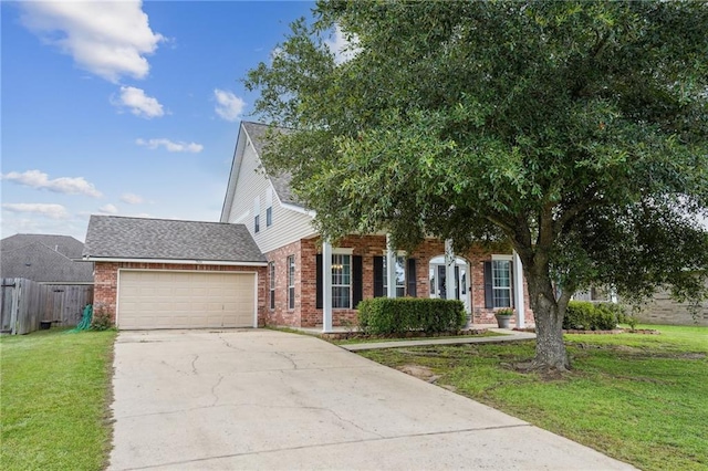 view of front of property featuring a garage and a front yard