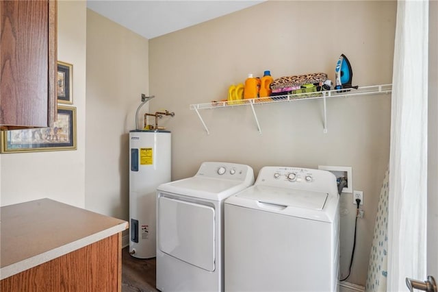 washroom featuring electric water heater and washer and clothes dryer