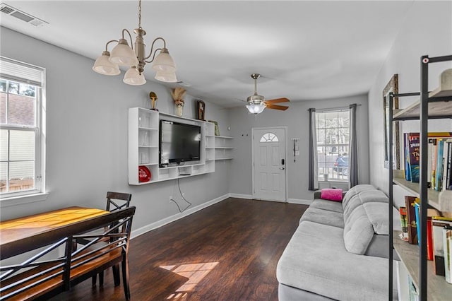 living room with dark hardwood / wood-style flooring and ceiling fan