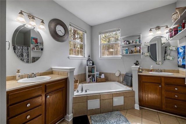 bathroom with vanity, a relaxing tiled tub, and tile patterned floors