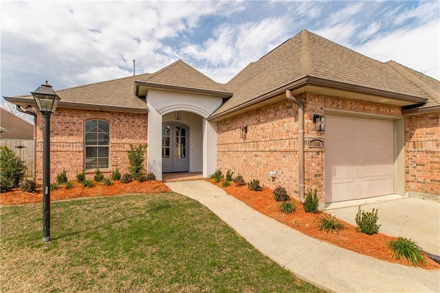 view of front of property with a garage and a front yard