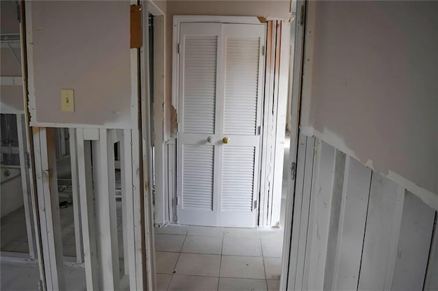 hall with light tile patterned floors