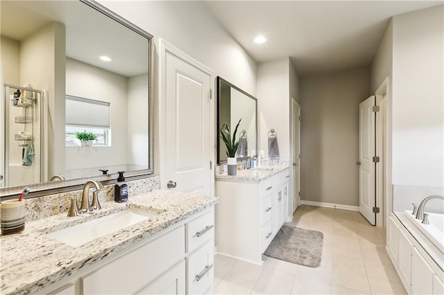 bathroom with vanity, a bath, and tile patterned flooring