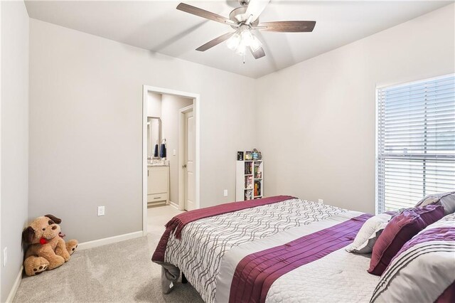 carpeted bedroom featuring ensuite bathroom and ceiling fan