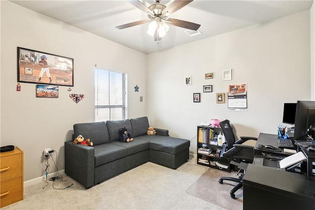 carpeted office featuring ceiling fan