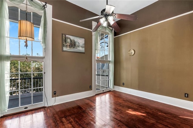 empty room featuring hardwood / wood-style floors and ceiling fan