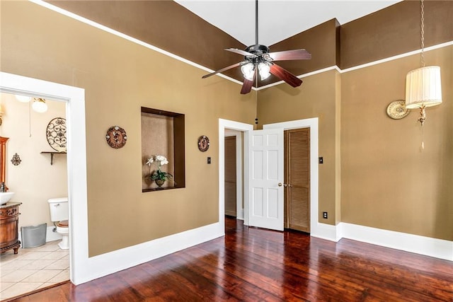 unfurnished room featuring hardwood / wood-style floors, high vaulted ceiling, and ceiling fan
