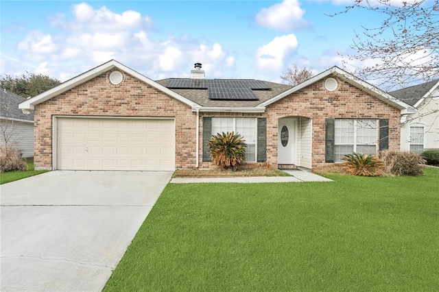 ranch-style house featuring a garage, a front yard, and solar panels