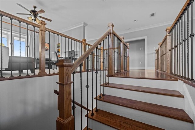stairs with ornamental molding and ceiling fan