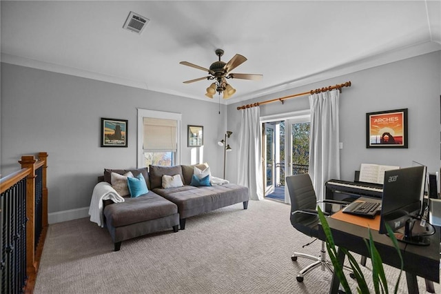 carpeted office featuring crown molding and ceiling fan