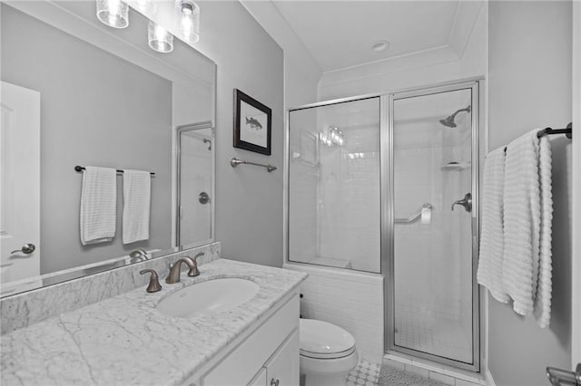 bathroom featuring vanity, a shower with door, and toilet