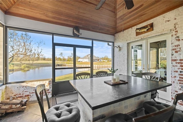 sunroom with a water view and wood ceiling