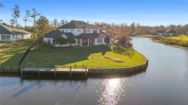 exterior space with a water view and a lawn