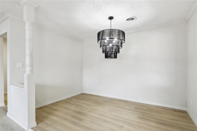 unfurnished room with crown molding, a notable chandelier, and light hardwood / wood-style flooring