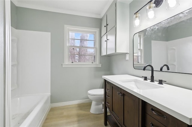 full bathroom featuring wood-type flooring, crown molding, vanity, toilet, and bathing tub / shower combination