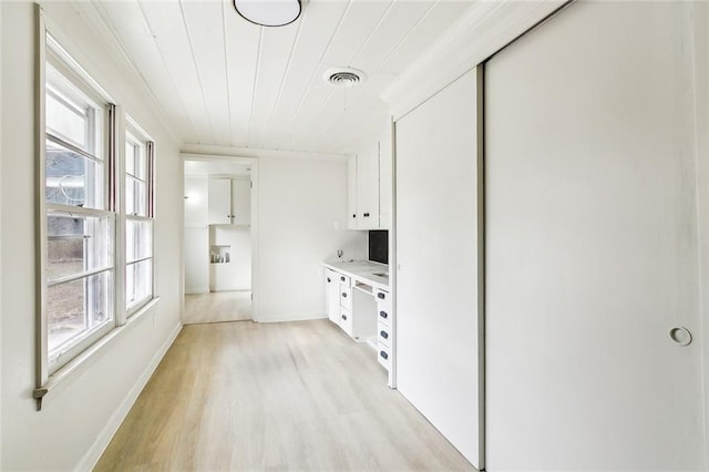 hall featuring white cabinetry, wood ceiling, and light hardwood / wood-style floors