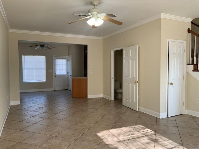 tiled empty room featuring crown molding and ceiling fan