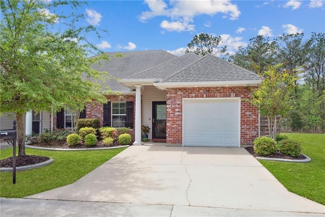 view of front facade with concrete driveway, brick siding, a front lawn, and an attached garage