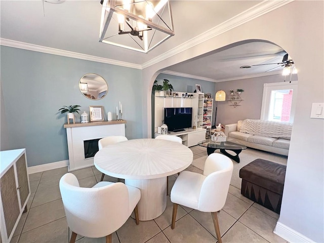 tiled dining room featuring crown molding and ceiling fan