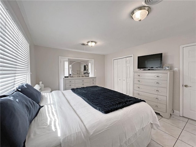 tiled bedroom with a closet