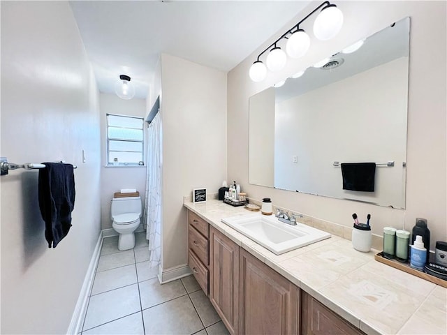 bathroom with tile patterned flooring, vanity, and toilet