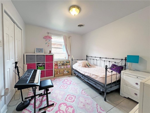 bedroom featuring a closet and light tile patterned flooring