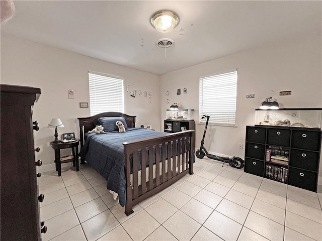 tiled bedroom featuring multiple windows