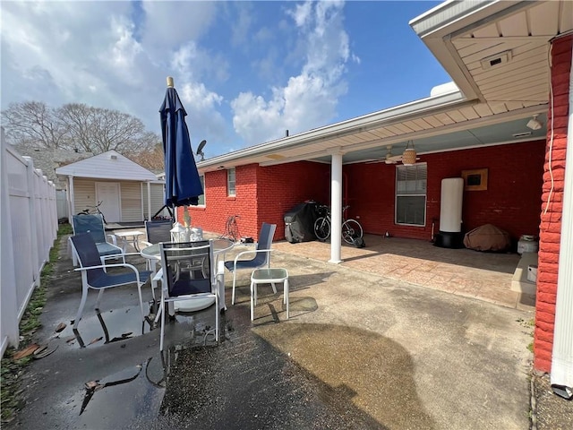 view of patio featuring an outbuilding and ceiling fan