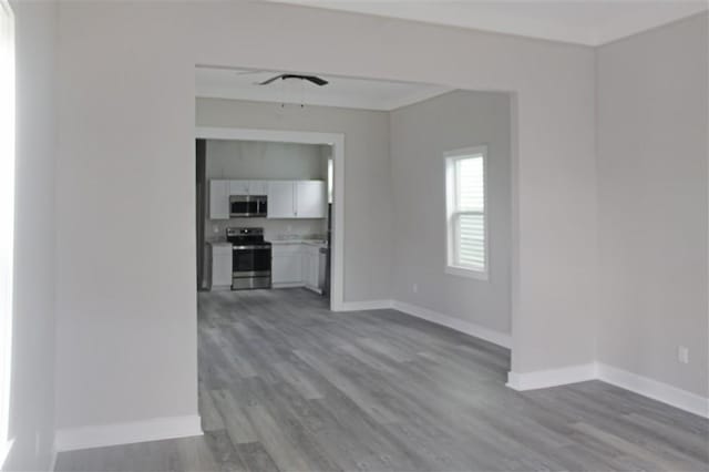 3533 S Liberty St, New Orleans, LA 70115 - unfurnished living room featuring wood finished floors and a ceiling fan